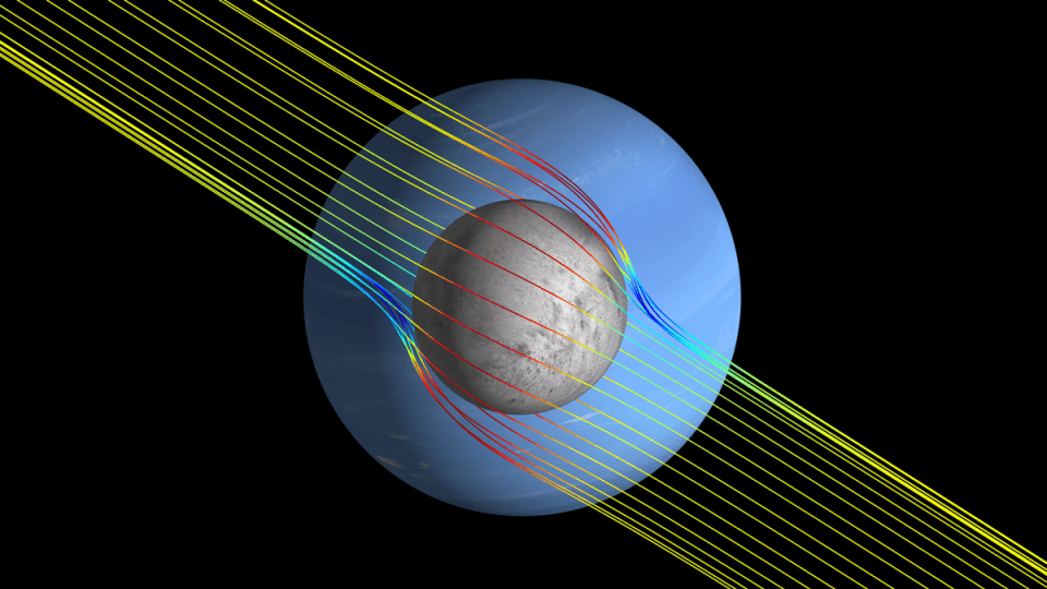 Líneas de campo magnético simuladas en amarillo alrededor de la luna de Saturno Triton.